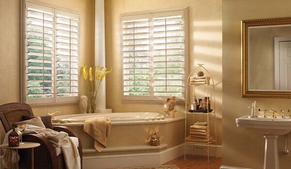 White Vinyl window shutters in pale yellow bathroom