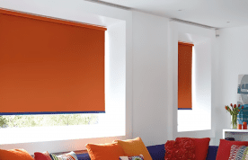 Orange roller blackout blinds in living room