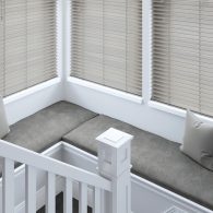 Wooden venetian blinds in bay window seat