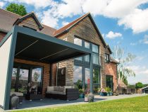 Outdoor pod with side panels over patio seating area